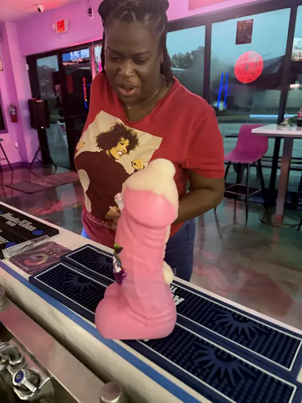 Guest showing off a Krazy novelty party cup at the bar